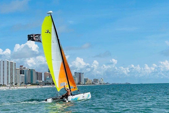 a man taking a sailboat ride in myrtle beach